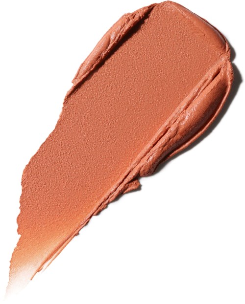 Een streep met perzikkleurige make-up of crème met een gladde, romige textuur.
