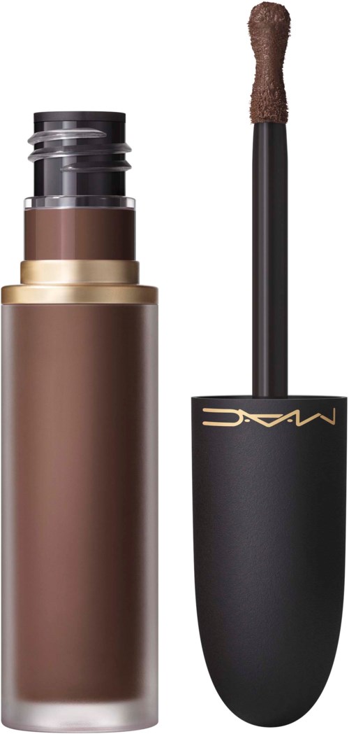 A makeup stick and brush, with the brush showing brown product and the brand MAC written on the black lid.