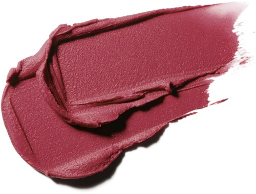 A smudged, pinkish red lipstick swatch on a white background.