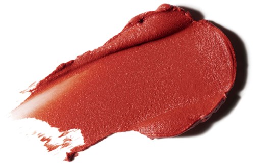 A red lipstick smear on white background, showing smooth, shiny texture and curved shape.