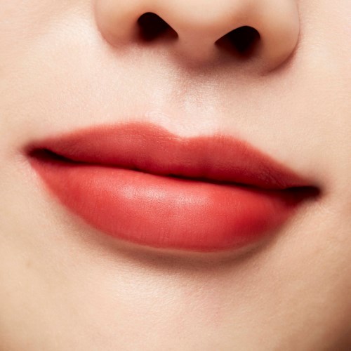 Close-up of lips with soft pink lipstick, smooth skin, and a well-defined shape.