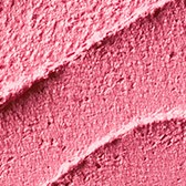 A close-up of pink, textured lipstick with a glossy finish and a smooth curve.
