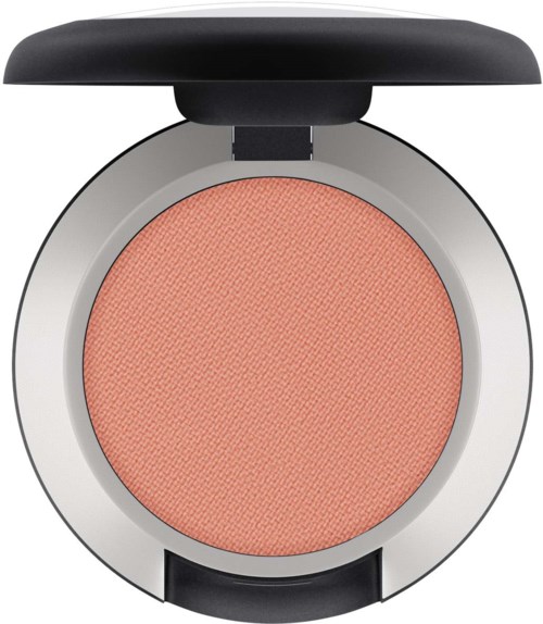 En rund blush med sort låg, korallfarvet og sølvbund. Det ligner makeup.