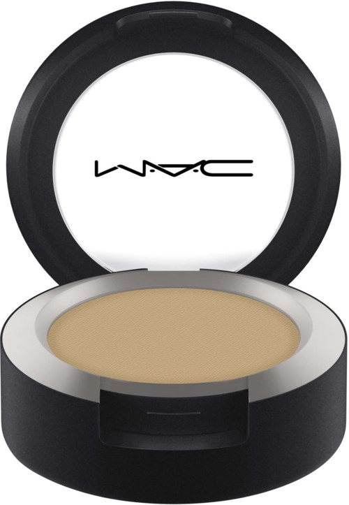En rund beholder med beige sminke inni og lokk med MAC-logoen, svart på utsiden og hvit inni.