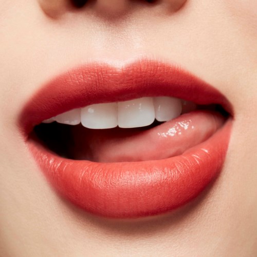 Nahaufnahme von leicht geöffneten Lippen, die Zähne und Zunge zeigen, mit glänzendem rosa Lippenstift.