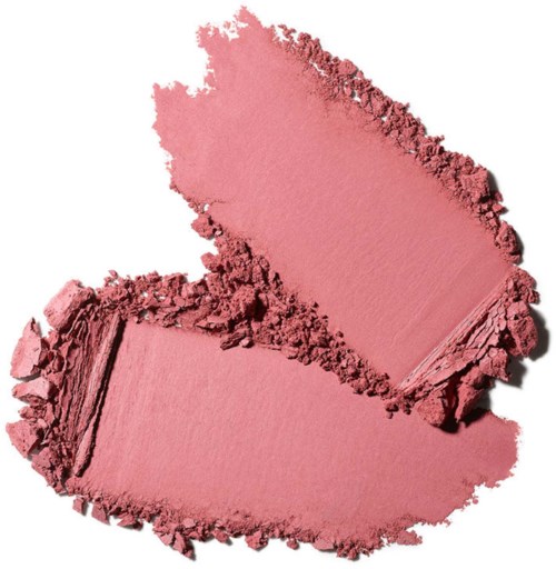 Brugt rosa kosmetikpulver i løs form, den ene del er glattere, den andre er mere ujævn.