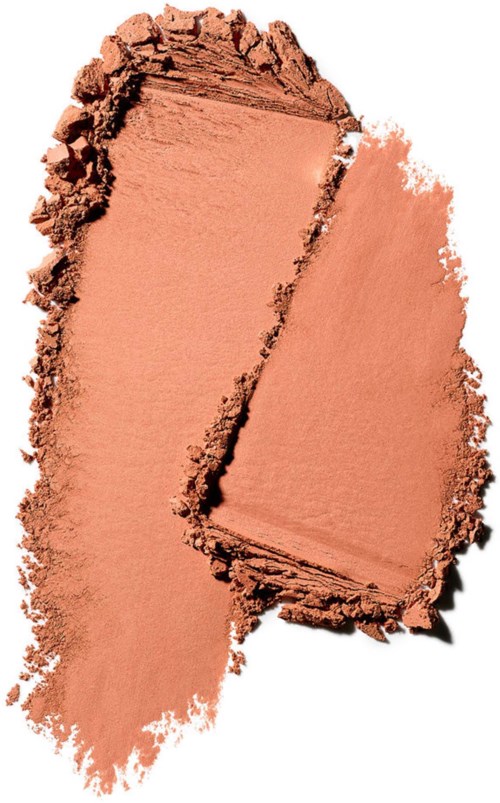 En ferskenfarvet pudder eller makeup spredt på en overflade med en sektion, der viser forskellige teksturer.