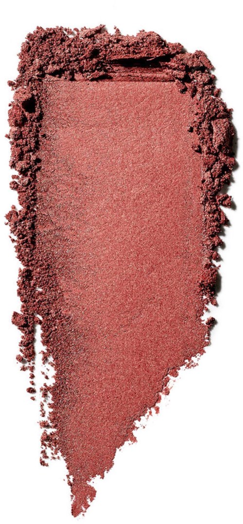 En lyserød makeup blush med ujævn kant, spredt ujævnt på en overflade.