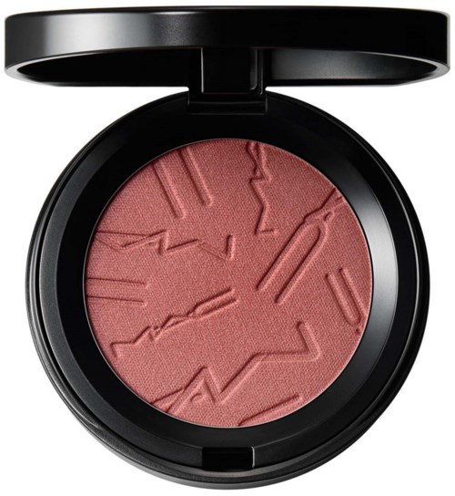 En rund rosa blush i en sort kompakt med teksturerede, abstrakte mønstre på overfladen.