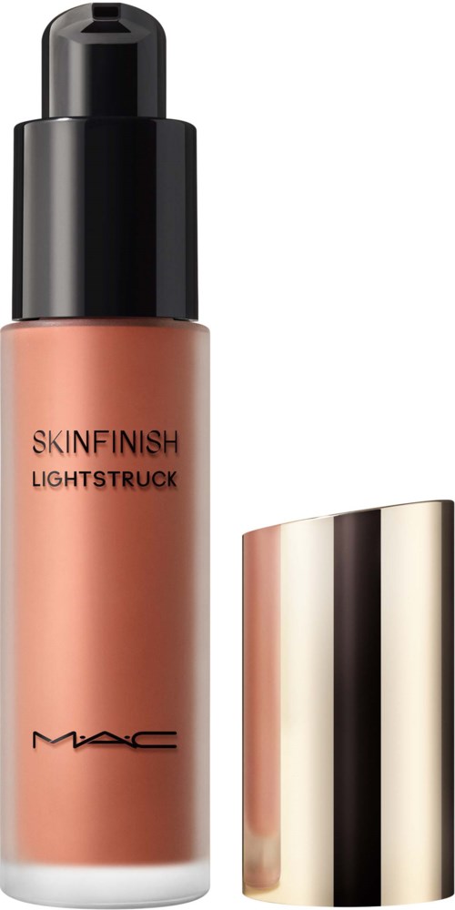 En flaske MAC Skinfinish Lightstruck flydende makeup med en blank gullhætte ved siden af.