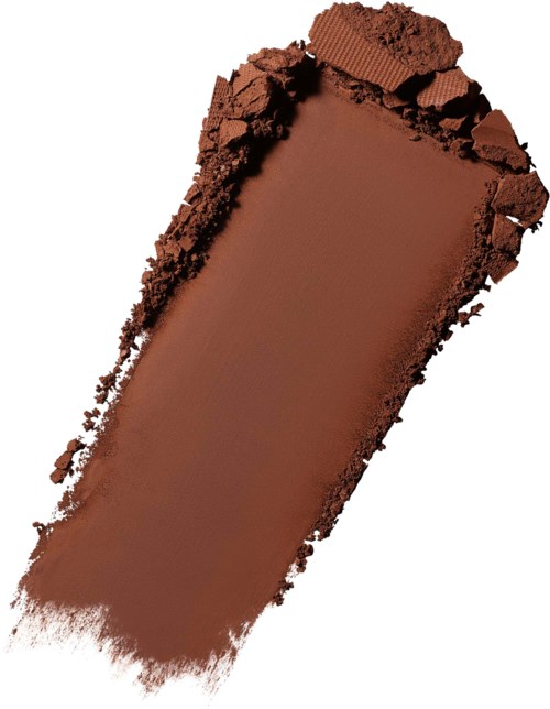 Et stykke af bruntchokolade med nogle krummer og en glat overflade.