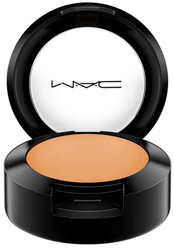 Eine runde Makeup-Box mit Spiegel, enthält beige Puder und hat die Marke MAC innen.