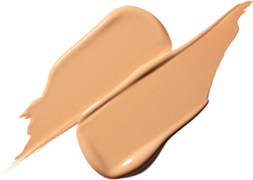 Een beige vloeistof uitgesmeerd met een kwast, met pannenkoek-achtige vormen en strepen.