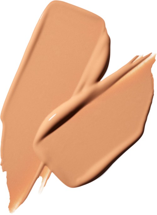 Een beige vloeistof of crème gesmeerd met een dikke textuur op een witte achtergrond.