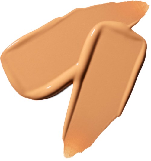 Een beige vloeibare foundation getest met een kwast, toont een romige textuur en egale dekking.