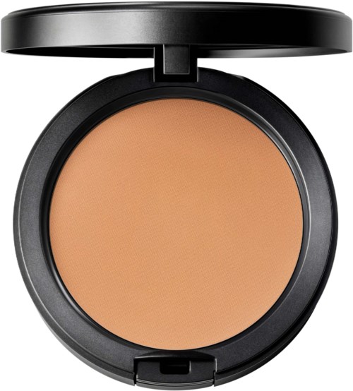 A compact makeup powder in a round black case with a lid open, showing light brown pressed powder inside.