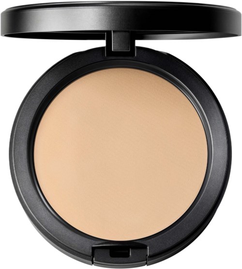 A round compact with beige powder inside and a black lid opened. The product looks like makeup or face powder.