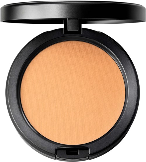 A round compact with a black lid open, showing peach-colored pressed powder inside.