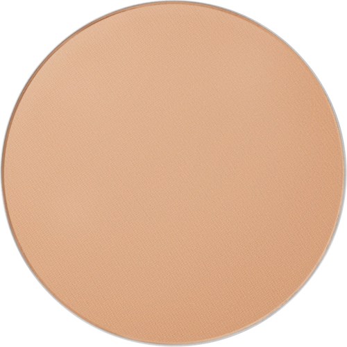 A round makeup compact with beige powder inside.