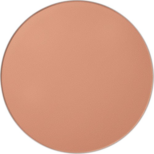 The image shows a large round makeup compact with a peach-colored powder inside.