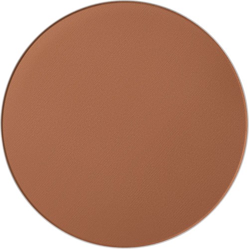 En rund makeup-compact i en varm brun nyans.