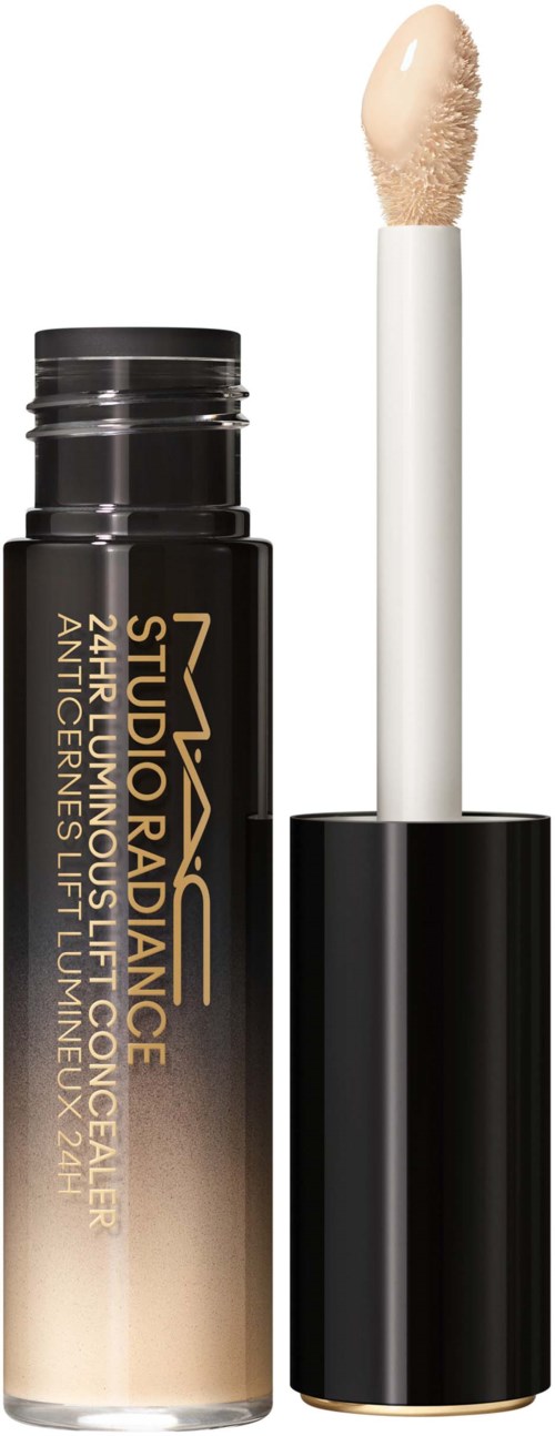 Een stick foundation-container met een verwijderbare applicatorborstel, zwart en goud verpakt, gemerkt "Studio Radiance".