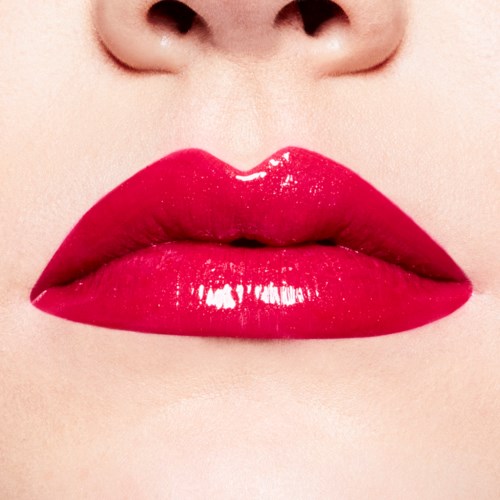 Close-up of lips with bright red, glossy lipstick.