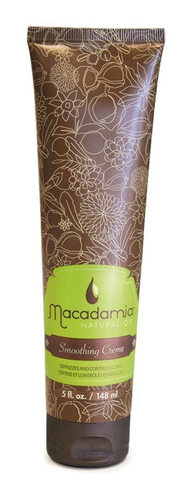 Ett brunt rör med blomster-mönster och en grön etikett för Macadamia Smoothing Creme, 5,1 ounces.