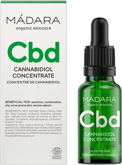 A green glass bottle and a box show CBD cannabidiol oil, emphasizing natural skincare benefits.