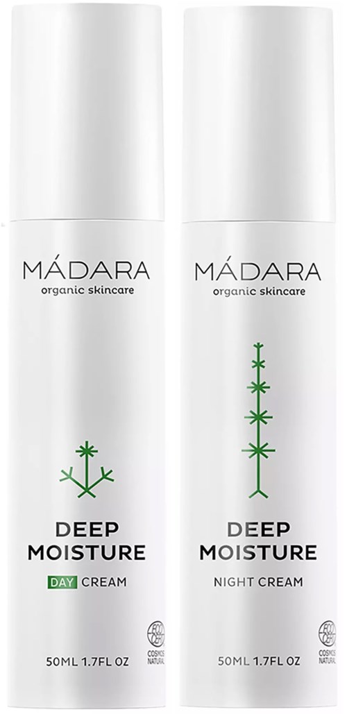 Två vita flaskor märkta Mádara Deep Moisture Day och Night Cream, med gröna växtsymboler, som visar att det är hudvårdsprodukter.