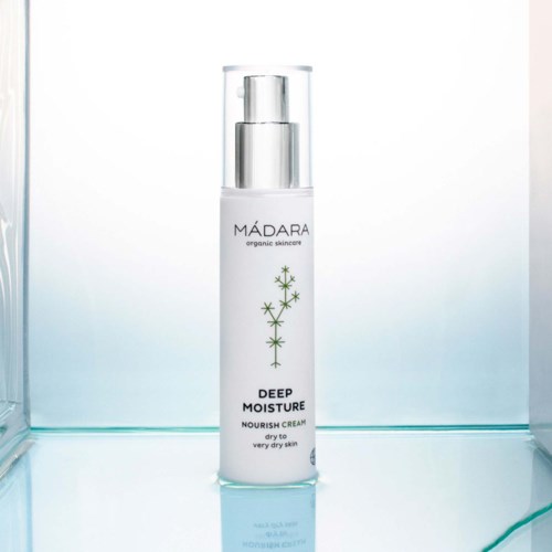 A white bottle with a pump named 'MADARA deep moisture nourish cream' for very dry skin.