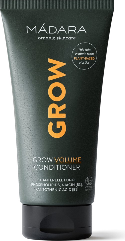Groene tube van Madara Grow Volume Conditioner met oranje en witte tekst, benadrukt biologische huidverzorging en plantaardige plastics.