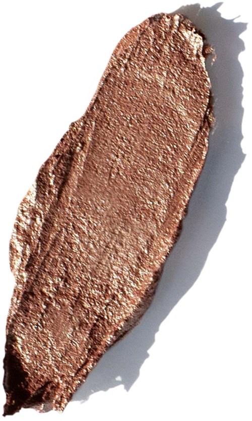 A smear of shiny bronze-colored makeup or paint on a white background, with a shadow on the right side.