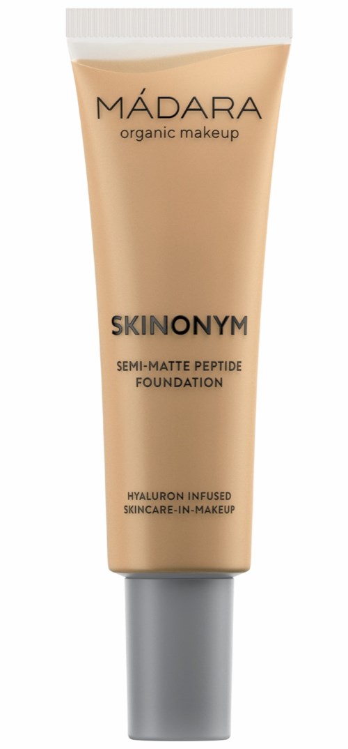 En beige tub med grått lock, märkt 'MADARA SKINODYM Foundation' och beskriver ingredienser och syfte.