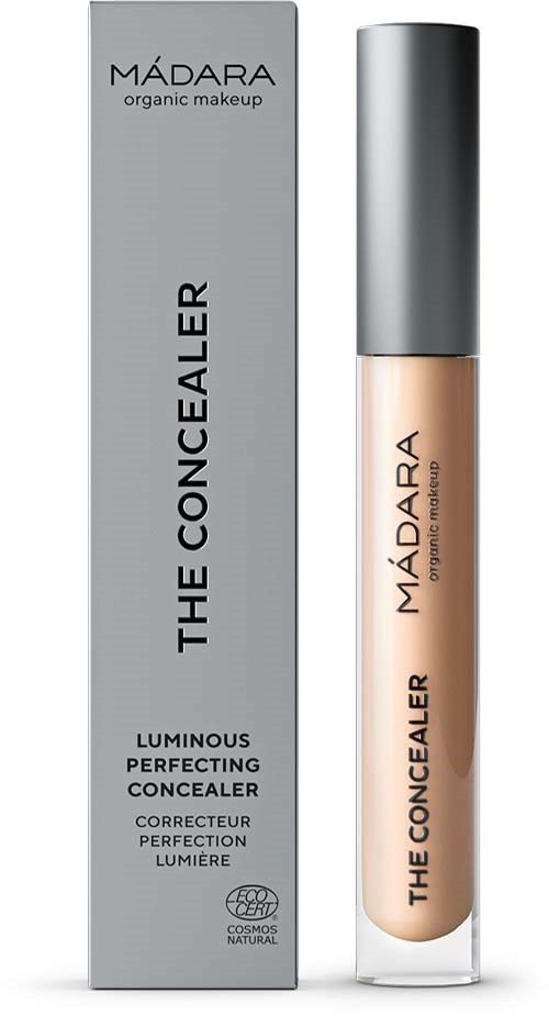 Ein Concealer-Flasche und eine Box mit der Aufschrift 'Madara The Concealer' mit grauem Deckel und heller beige Flüssigkeit.