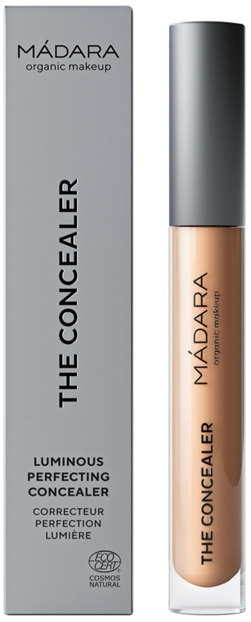 A concealer bottle and box, labeled 'MADARA THE CONCEALER,' in black and beige colors.