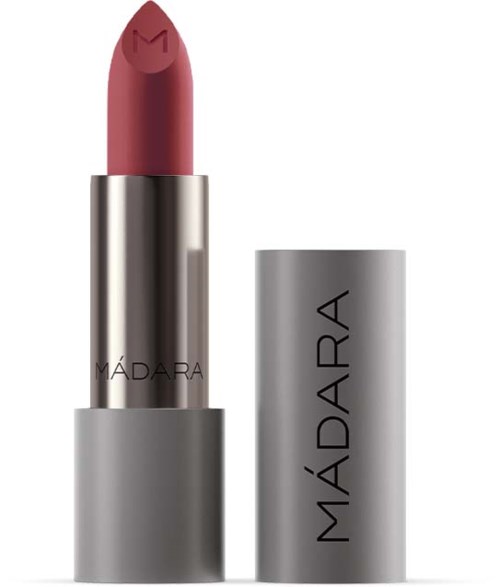 A lipstick with a pink shade and a silver tube, labeled 'MADARA', standing upright with the cap nearby.