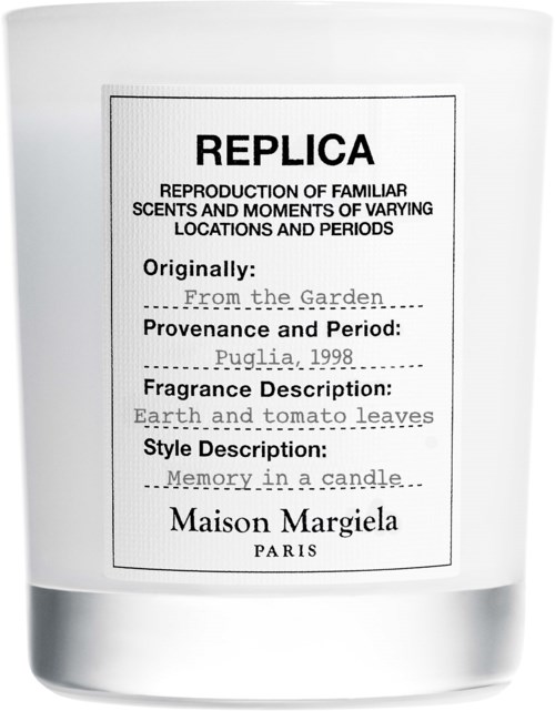 A candle with a label describing it as a replica of a earth and tomato leaves scent, by Maison Margiela.