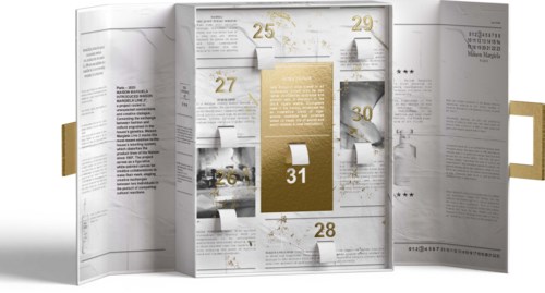 A gold and white advent calendar with numbered doors for each day, decorated with stars and gold accents.