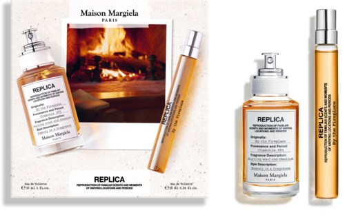 Packaging images of Maison Margiela Replica fragrances with a photo of a fireplace in the background.