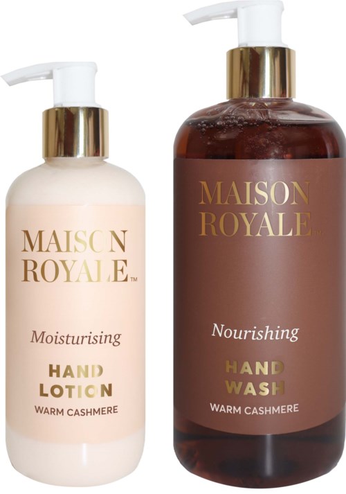 To lotionflasker, en hvit og en brun, merket 'Hand Lotion' og 'Hand Wash' med gulldetaljer.
