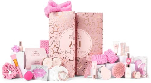 Sminkprodukter i rosa och vitt med en stor rosa rosett och stjärndekorationer, arrangerade runt en låda med stjärnmönster.