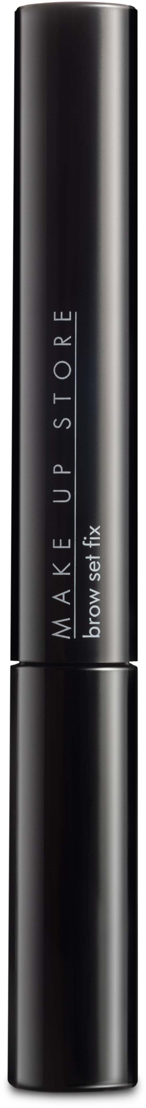 Ett svart cylindriskt sminkprodukt med vitt text, troligtvis en ögonbrynsgel eller mascara, mot en svart bakgrund.