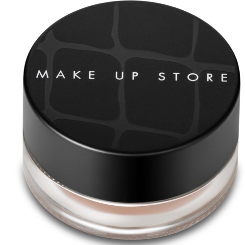 En liten rund burk med svart lock och vit text som säger 'MAKE UP STORE' visas.