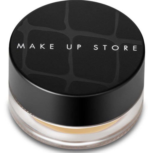 Ett runt sminkförpackning med svart lock som säger 'MAKE UP STORE' i vita bokstäver.