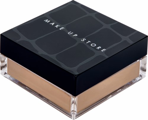 A makeup product in a clear container with beige powder and a black lid that says "MAKE UP STORE."