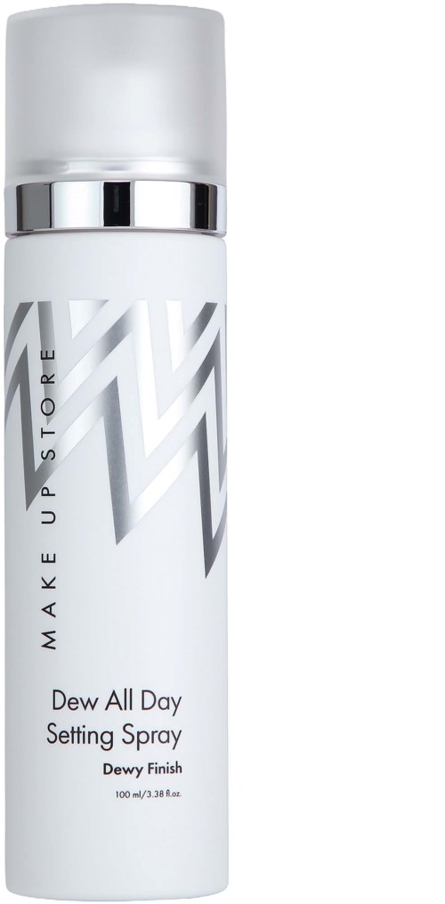 En vit sprayflaska med silverdetaljer och zigzag-design, märkt Dewy Finish setting spray.