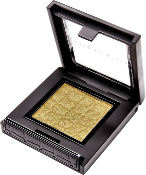 A black makeup compact open, showing a gold eyeshadow with a textured pattern inside.