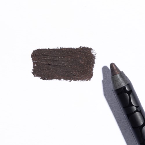 Ruskea eyelinerinäyte valkoisella paperilla, vieressä musta kynä.