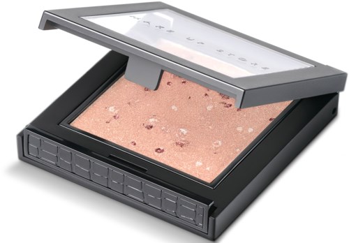 En kompakt makeup-palett med puder och transparent lock, används för ansikts- och ögonmakeup.
